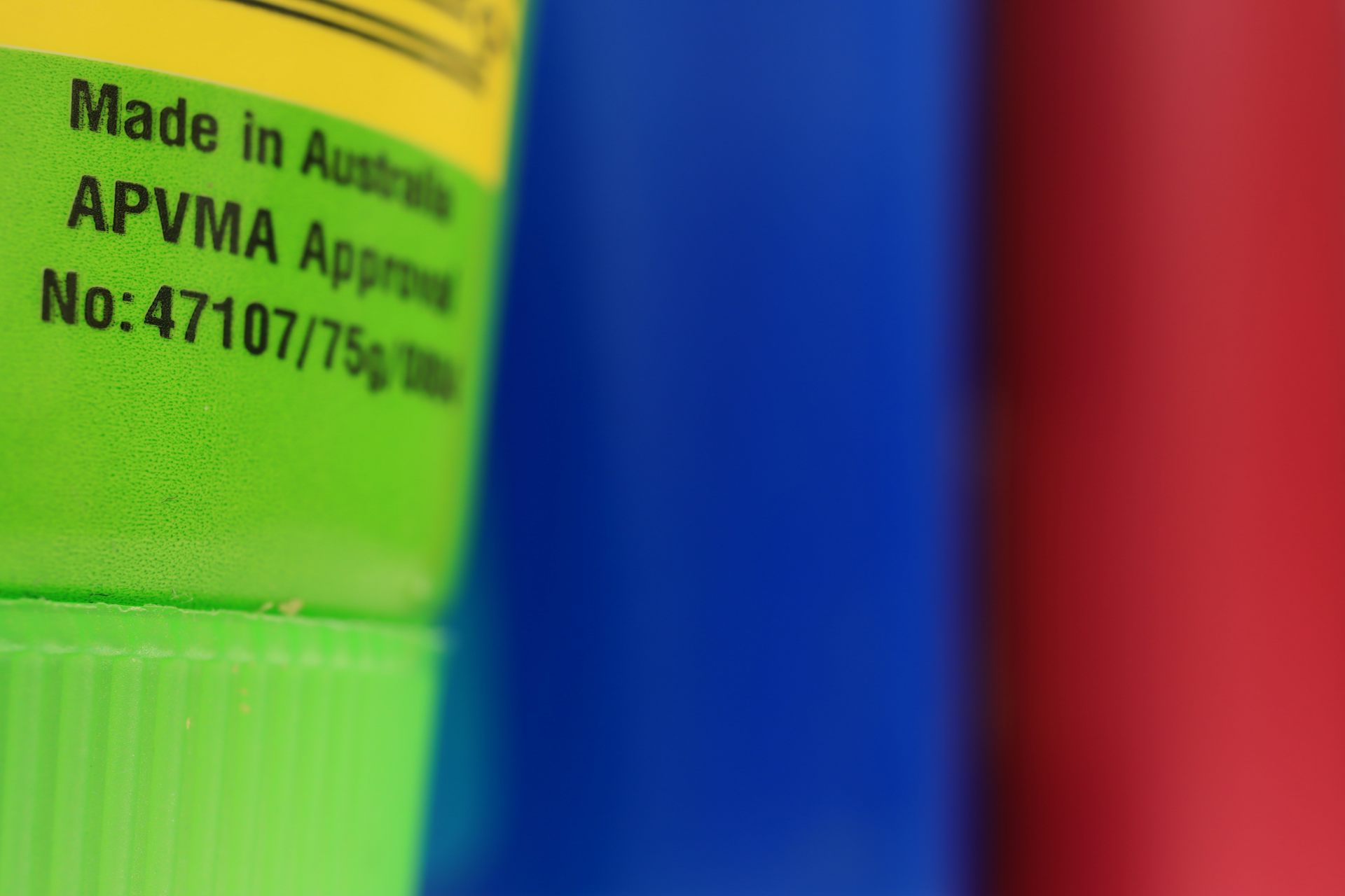 Three colourful containers of mosquito repellent