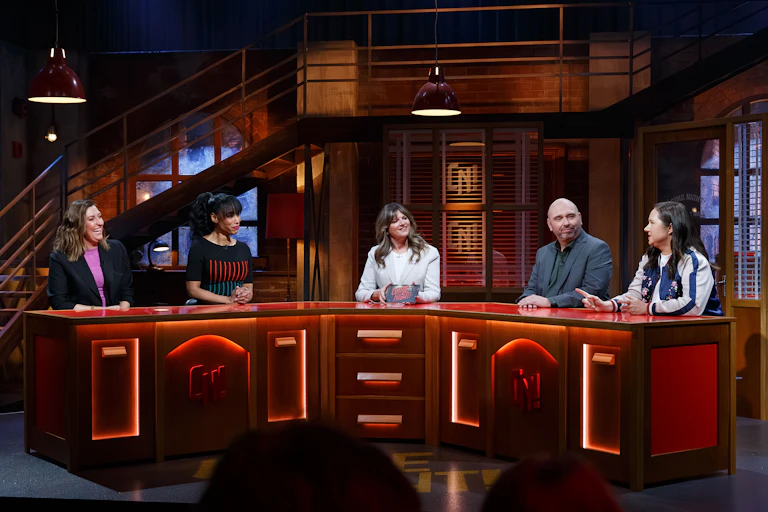 Five people on a panel in a studio.