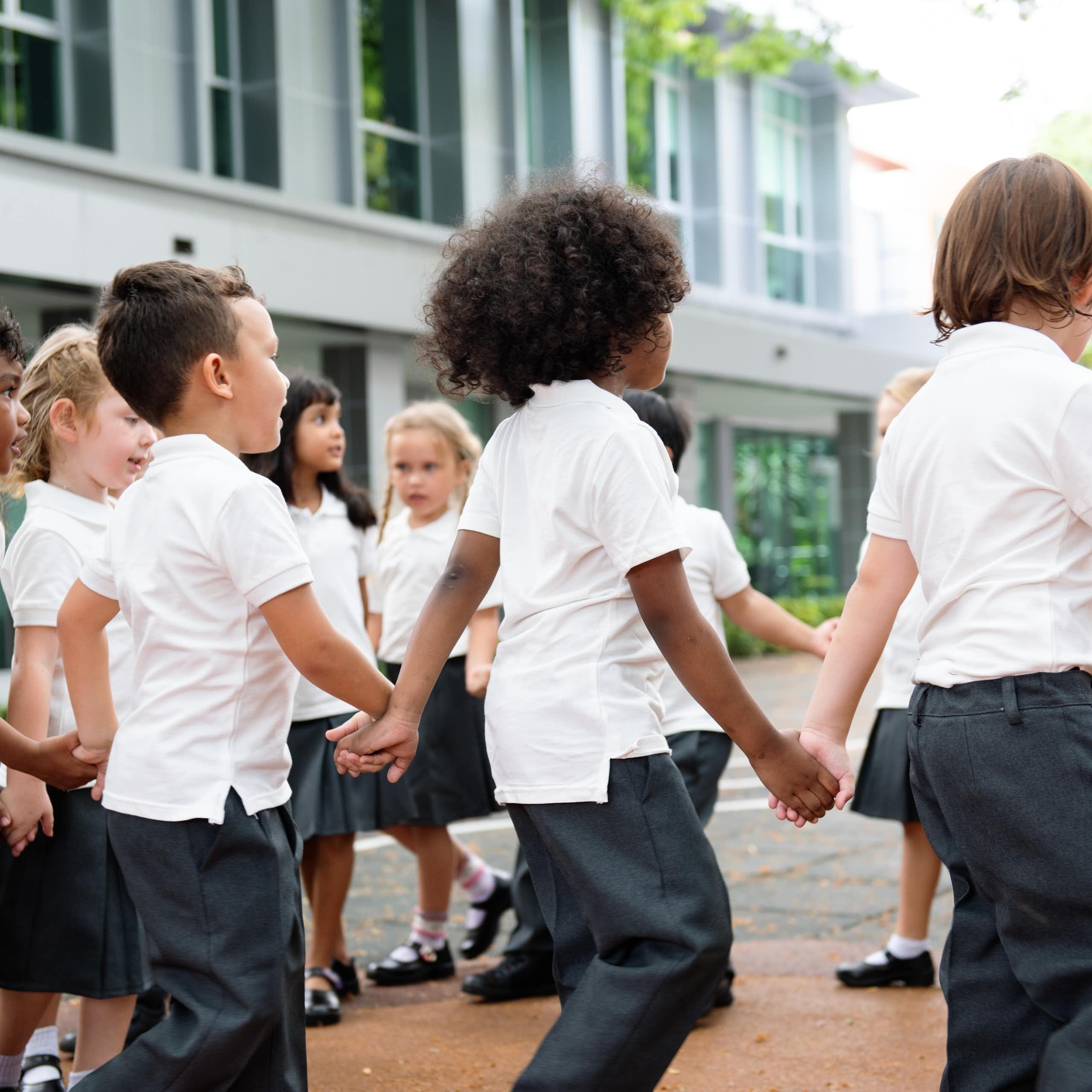Kids holding hands in a playground