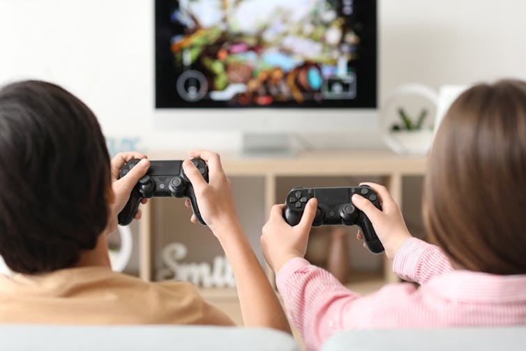 The psychology of era Alpha 1 Two kids playing a computer game