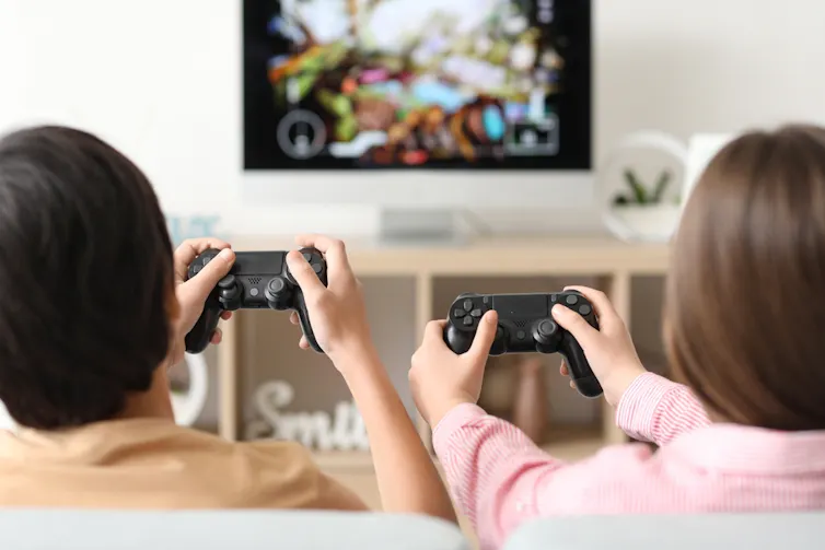 Two kids playing a computer game