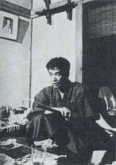 Japanese man sat in a room working