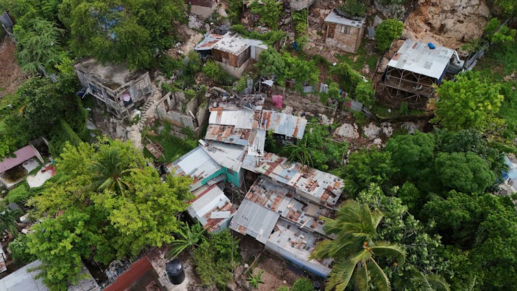 How one can inexperienced your cash 1 aerial shot of damaged houses on tropical island with palm trees