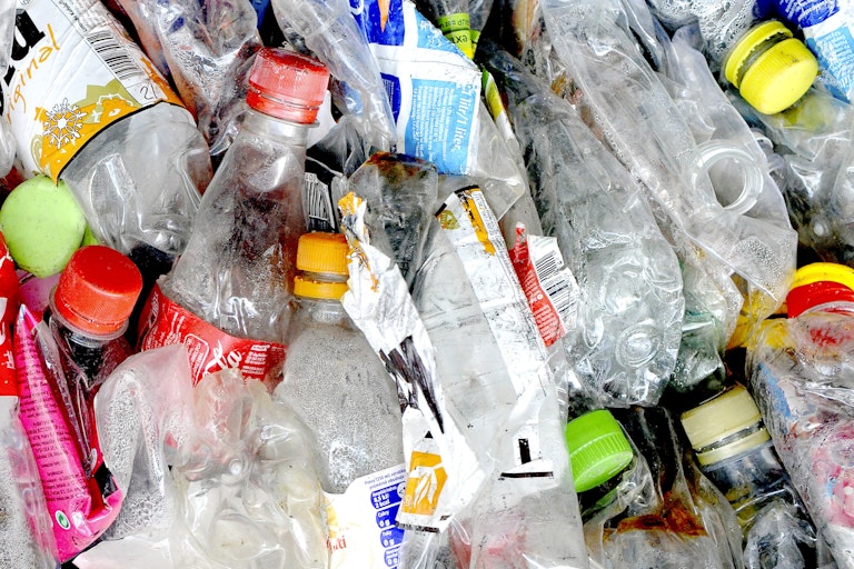 Plastic waste bottles and crushed plastic