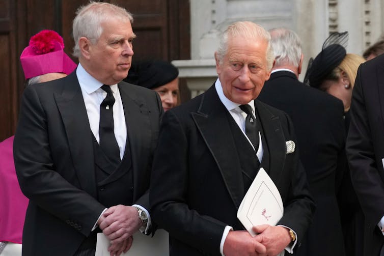 Prince Andrew and King Charles stand side by side.