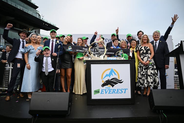Owners, trainers and family celebrate after jockey Craig Williams rides Bella Nipotina to victory in Race 7, the Everest