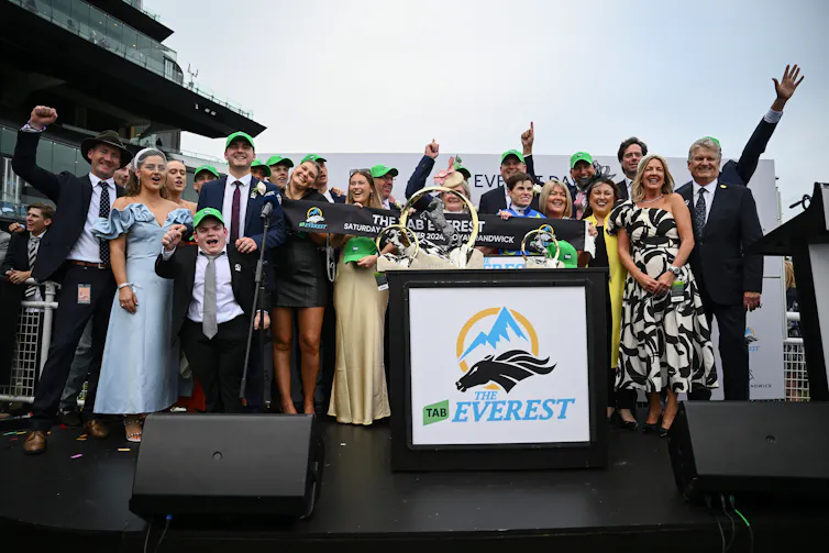 Owners, trainers and family celebrate after jockey Craig Williams rides Bella Nipotina to victory in Race 7, the Everest