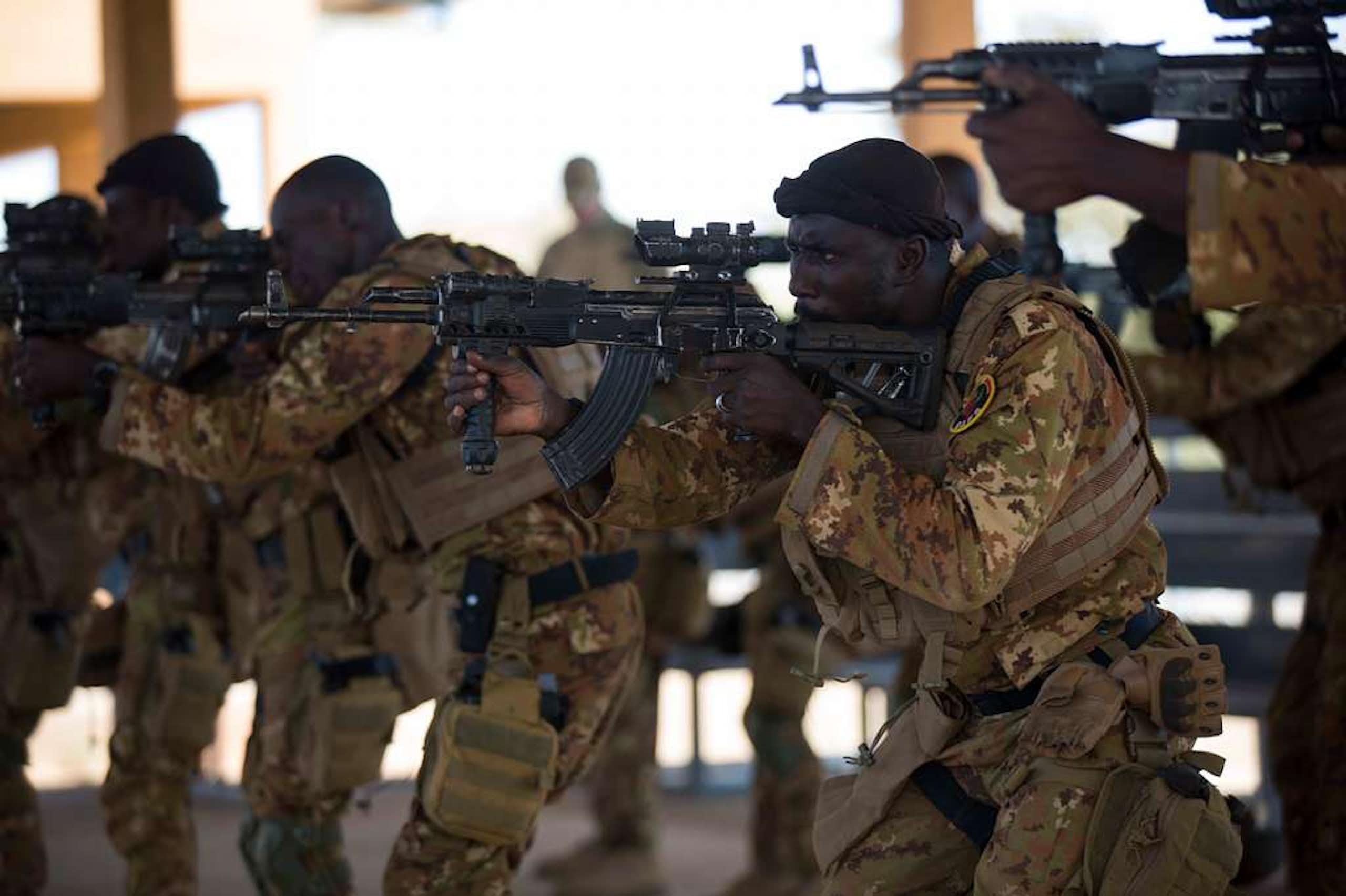Men in uniform pointing their rifles