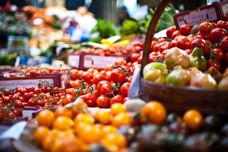 Piles of tomatoes at an open market.