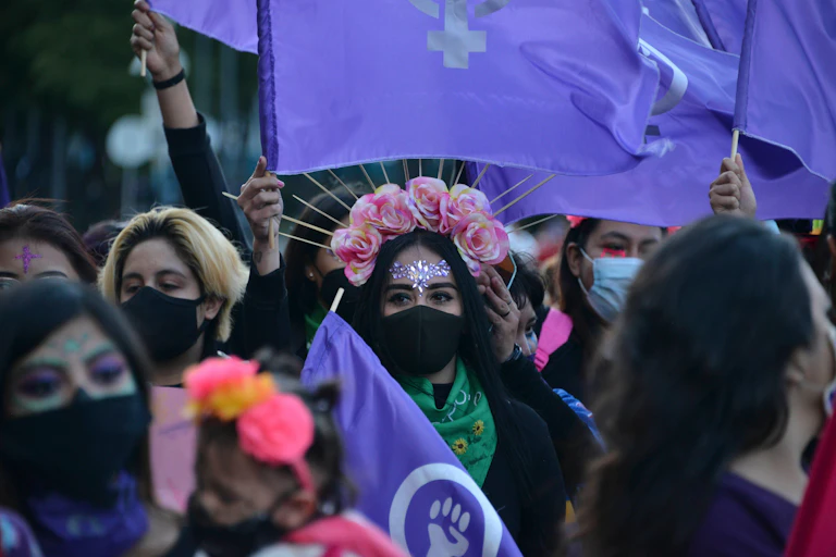Women dressed in traditional costume for a Day of The Dead protest march.