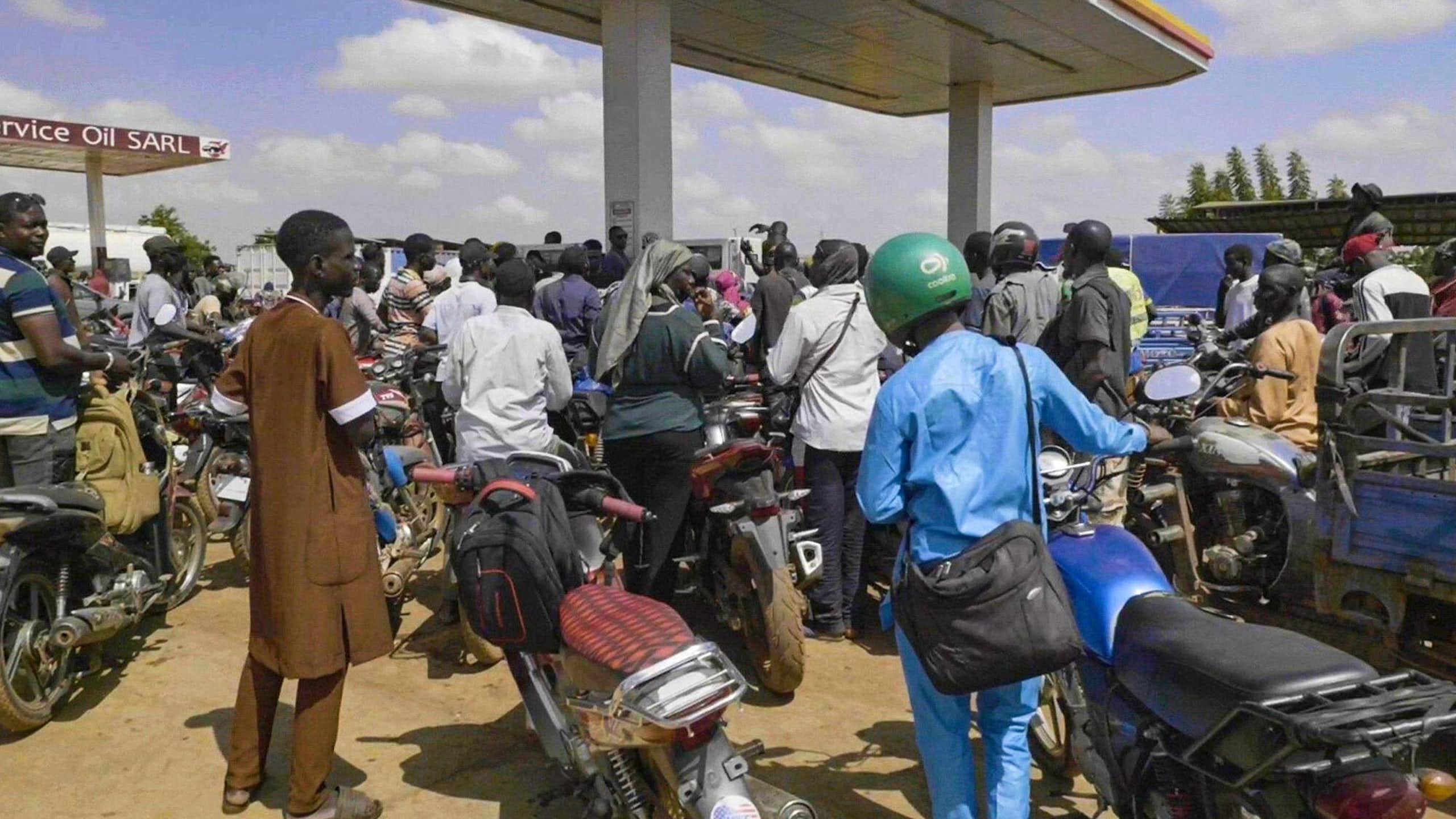 People in Mali queue with their motorcycles at a gas station amid a fuel shortage.