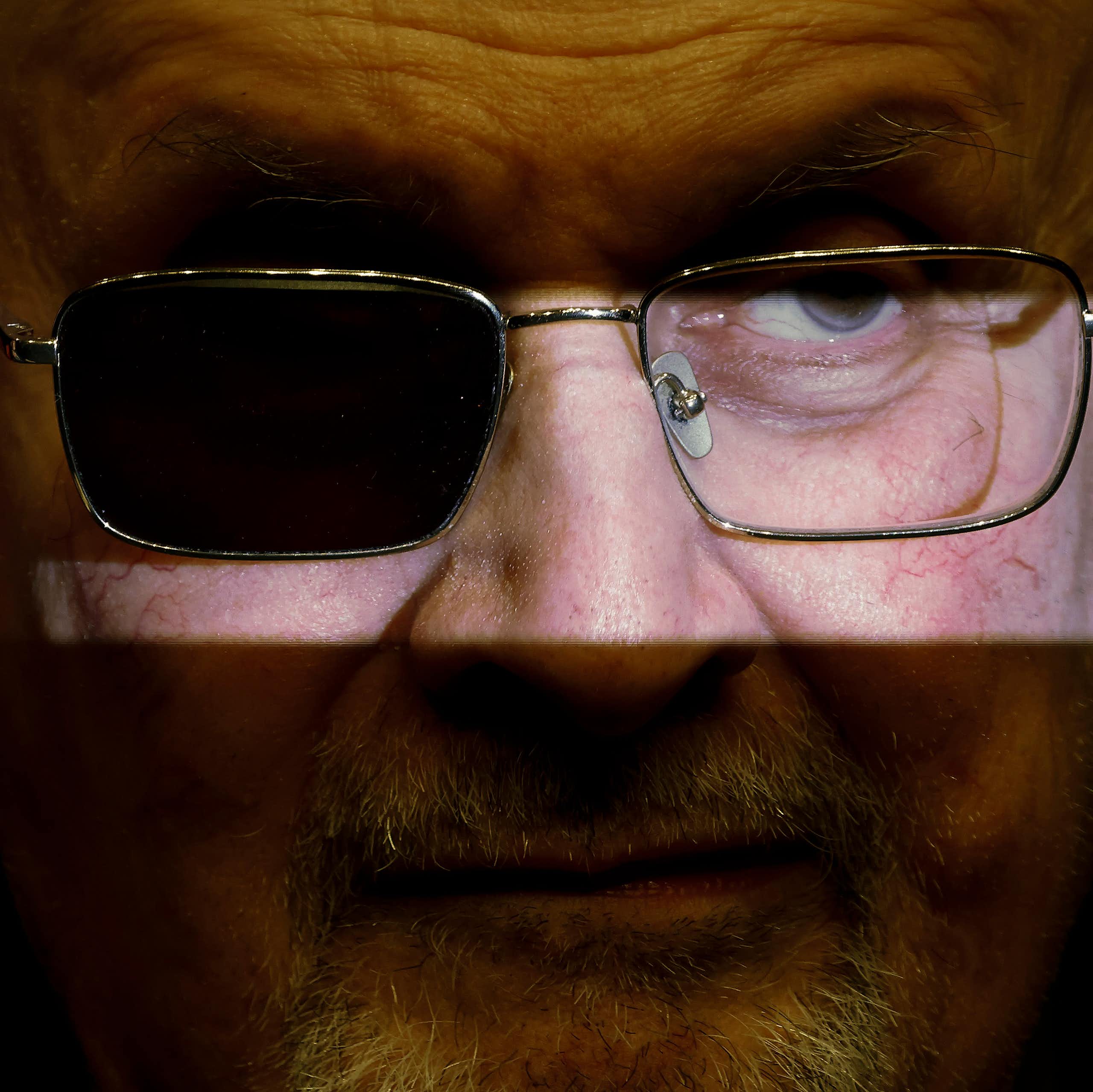 Salman Rushdie wearing glasses with one lens darkened