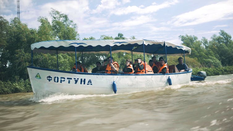 A boat filled with people in a wild part of Ukraine.