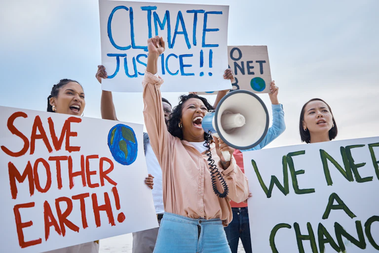 climate protestors shouting with signs calling for climate justice
