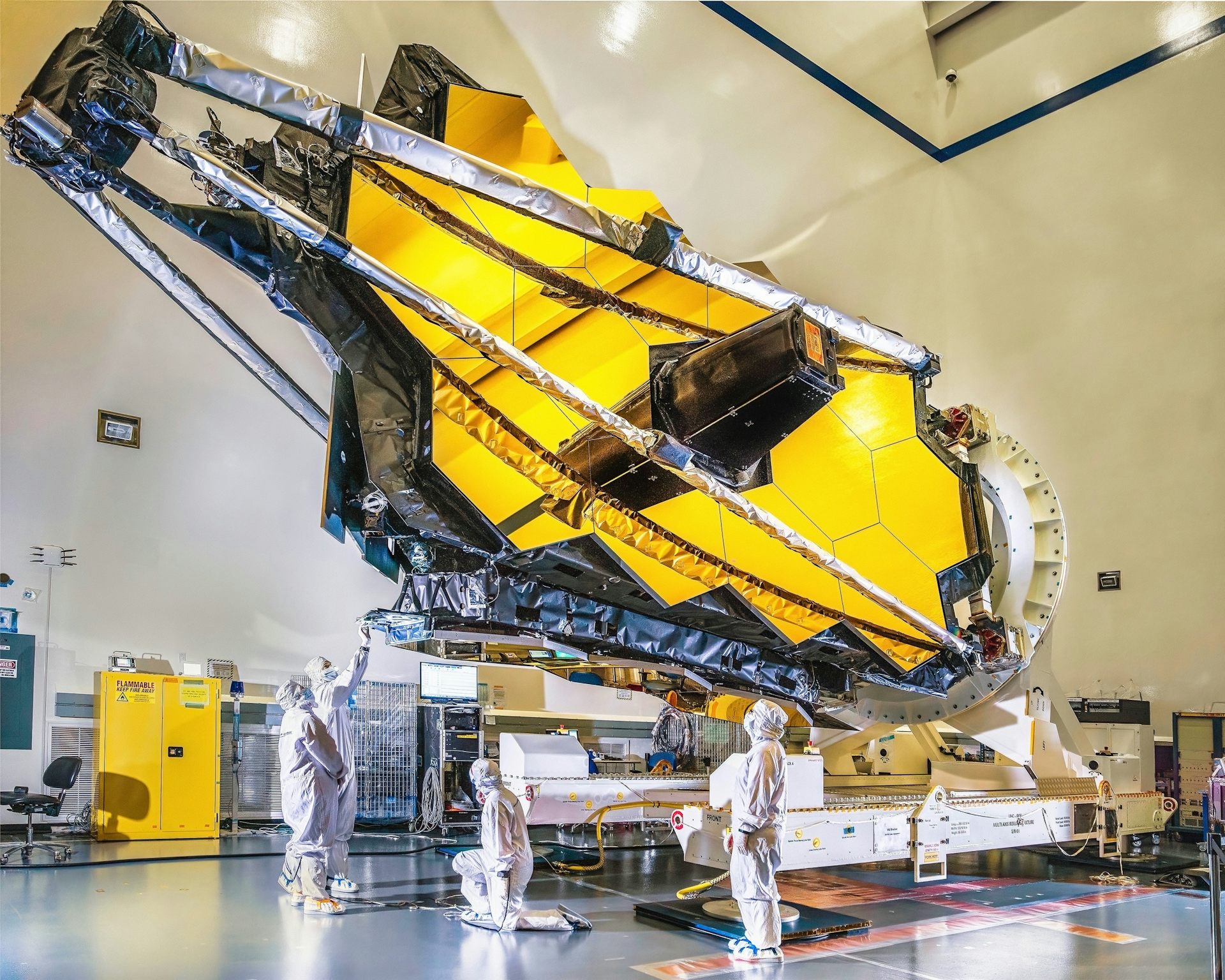 The James Webb space telescope inside a huge hangar like building.