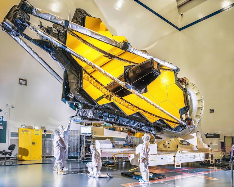 How a medieval Oxford friar used gentle and color to determine what stars and planets are made from 1 The James Webb space telescope inside a huge hangar like building.