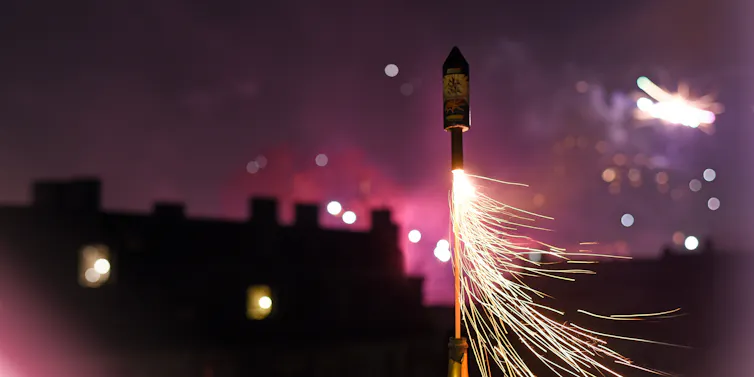 A lit firework is being launched into the sky.