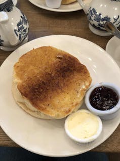 A giant tea cake with cream and jam