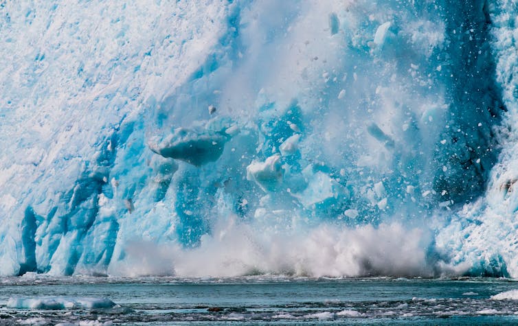 glacier crashing into sea