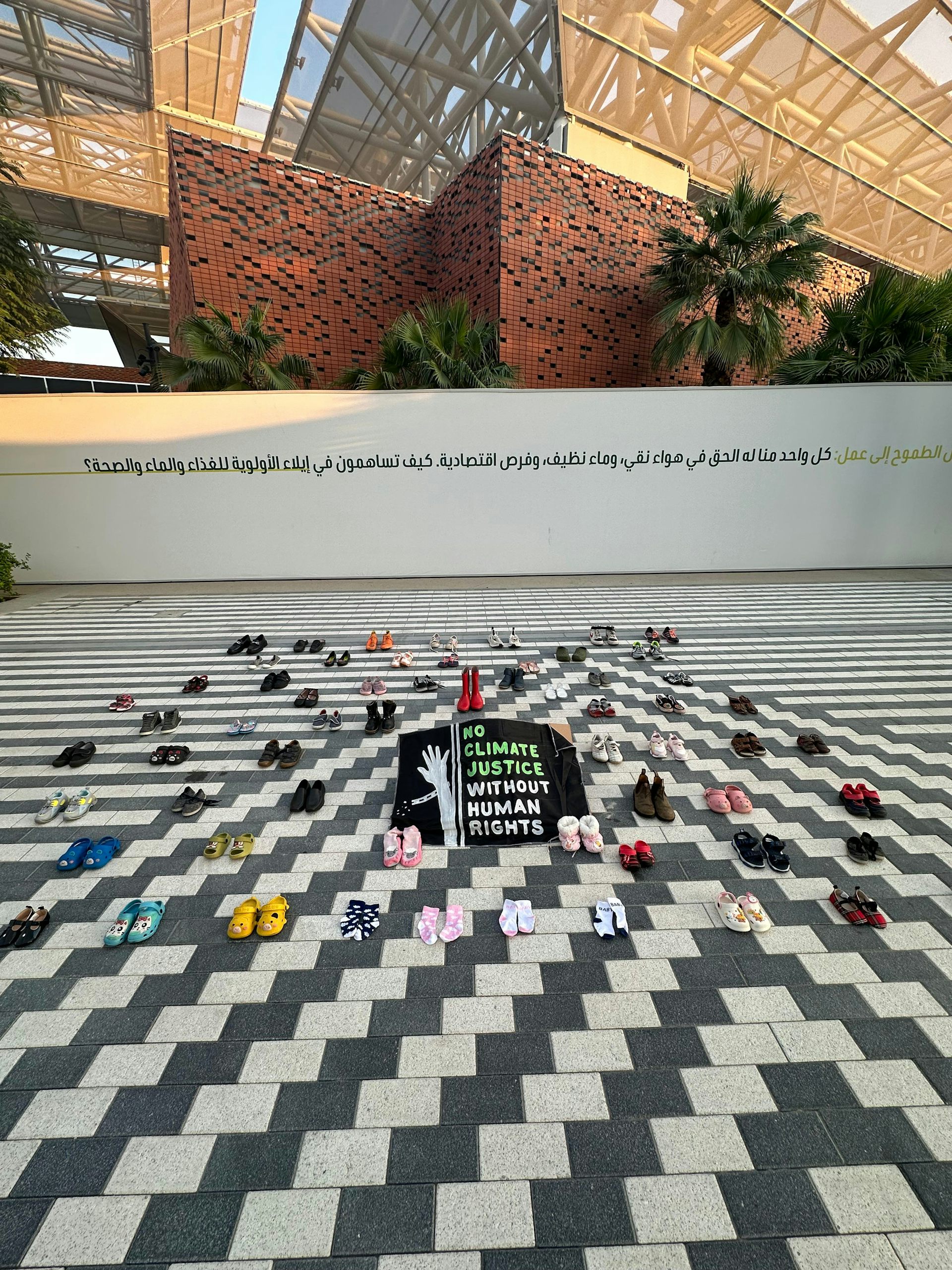 shoes laid out on black and white tiled floor
