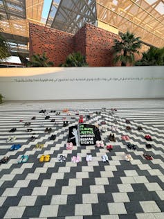 shoes laid out on black and white tiled floor