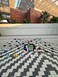 shoes laid out on black and white tiled floor