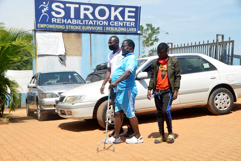 Two men helping a man to walk