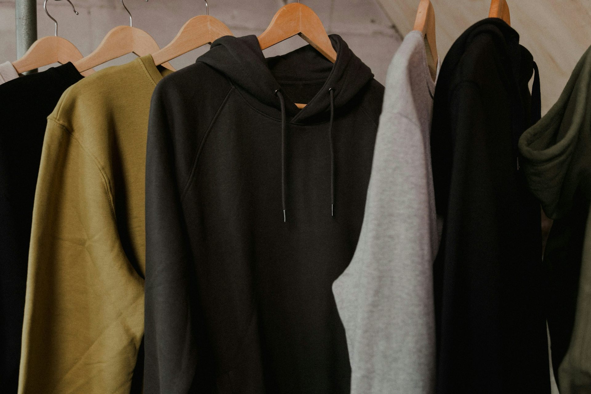 A row of hoodies on a rack