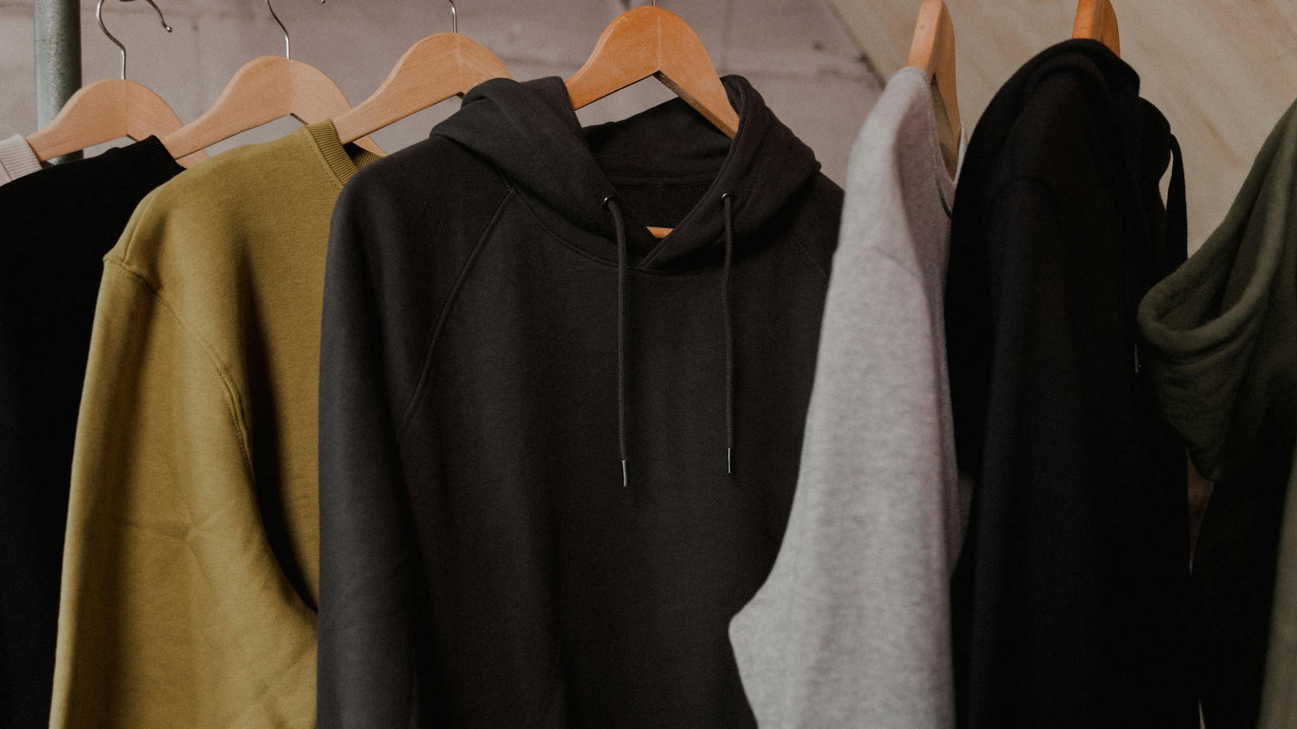 A row of hoodies on a rack