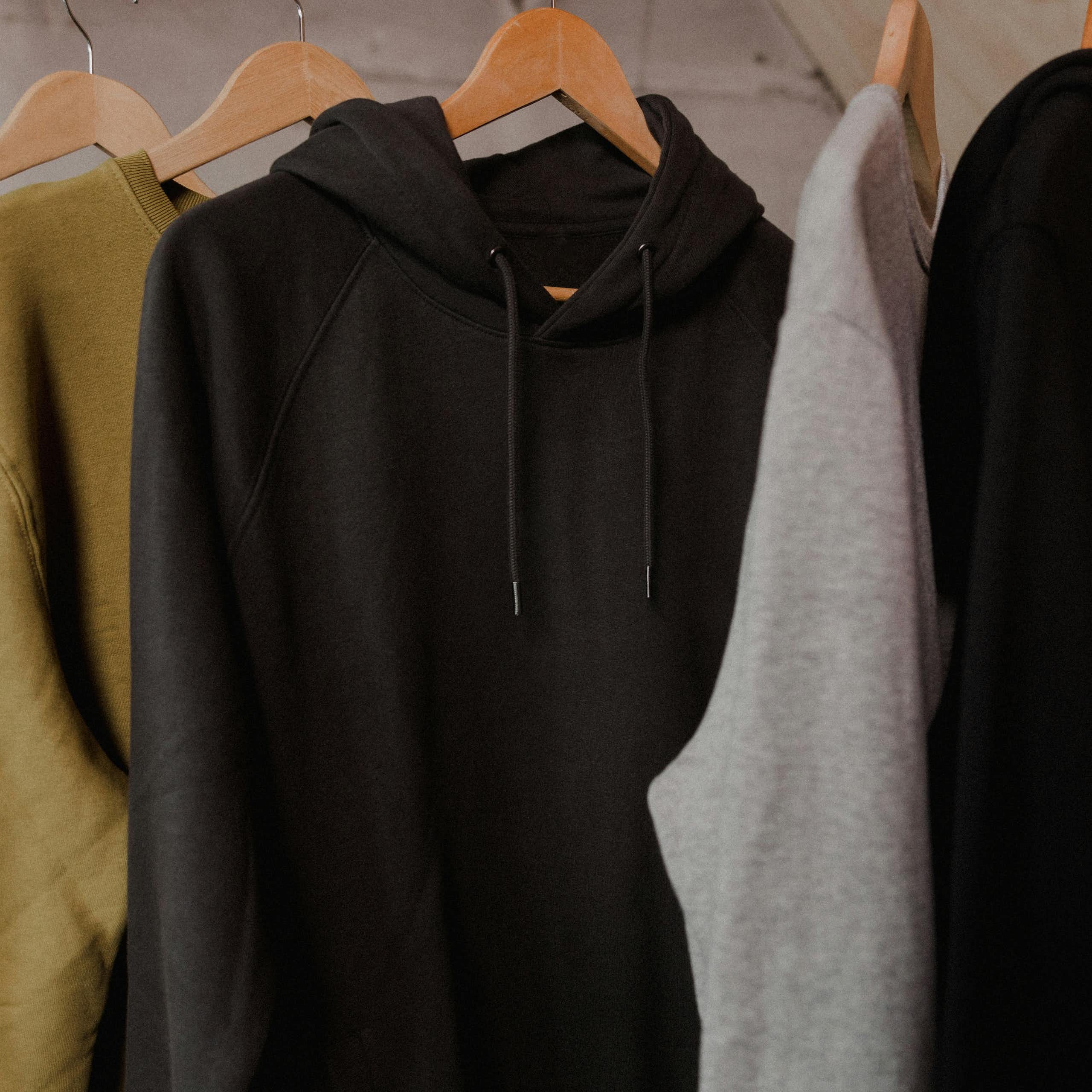 A row of hoodies on a rack