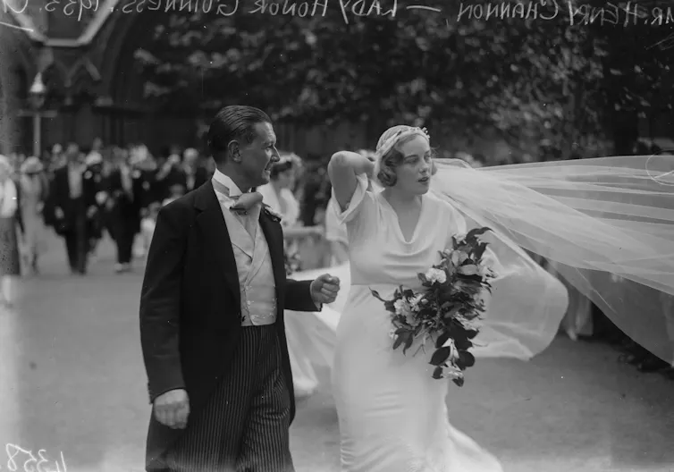 Just-married 1930s couple in morning suit and wedding dress.