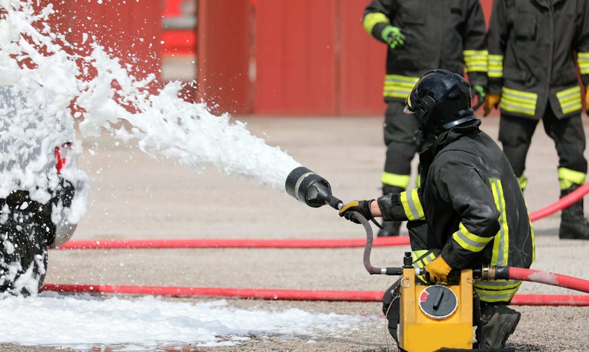 Firefighter using foam to put out a blaze.