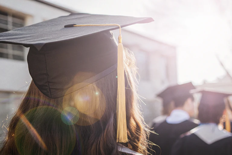 Graduate in moartarboard viewed from back
