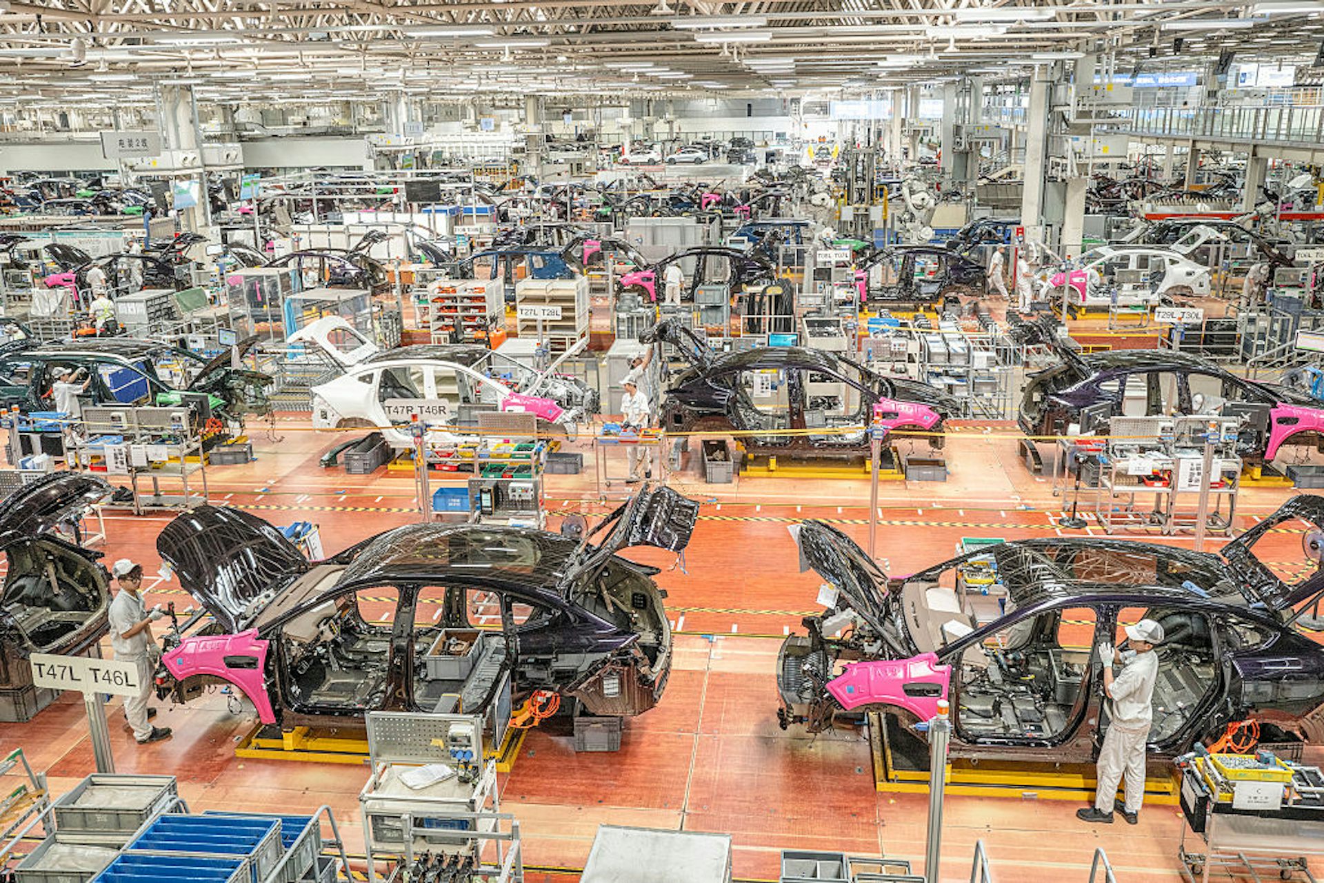 Car parts are fitted in a big warehouse.