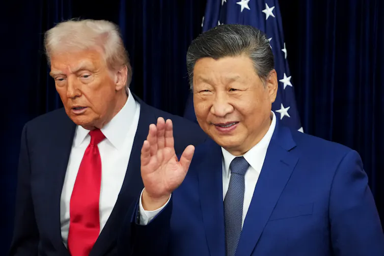 Two men in suits walk toward the camera, one waving.