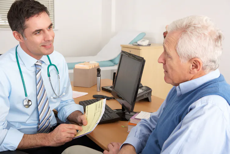 Older man talking to his GP.