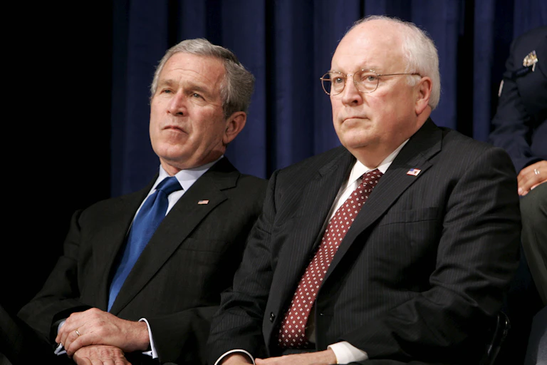 Dick Cheney sat beside George W. Bush Jr.