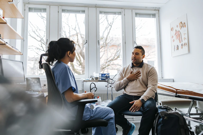 Man talks to his doctor about pain