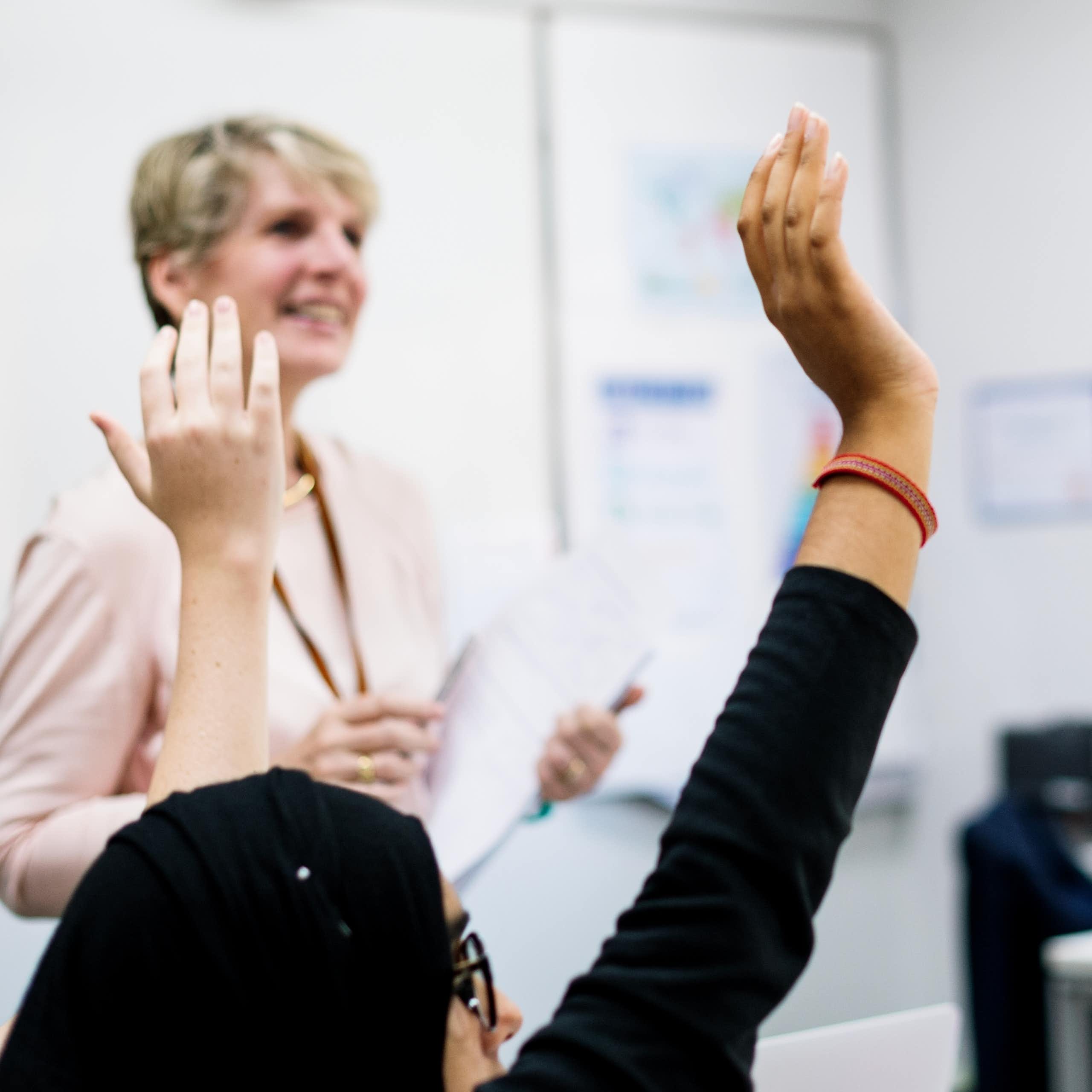 Pupils raising hands in class