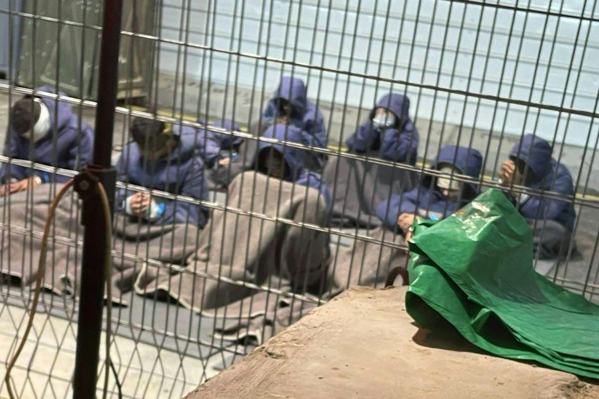 Palestinian men in a prison cell.