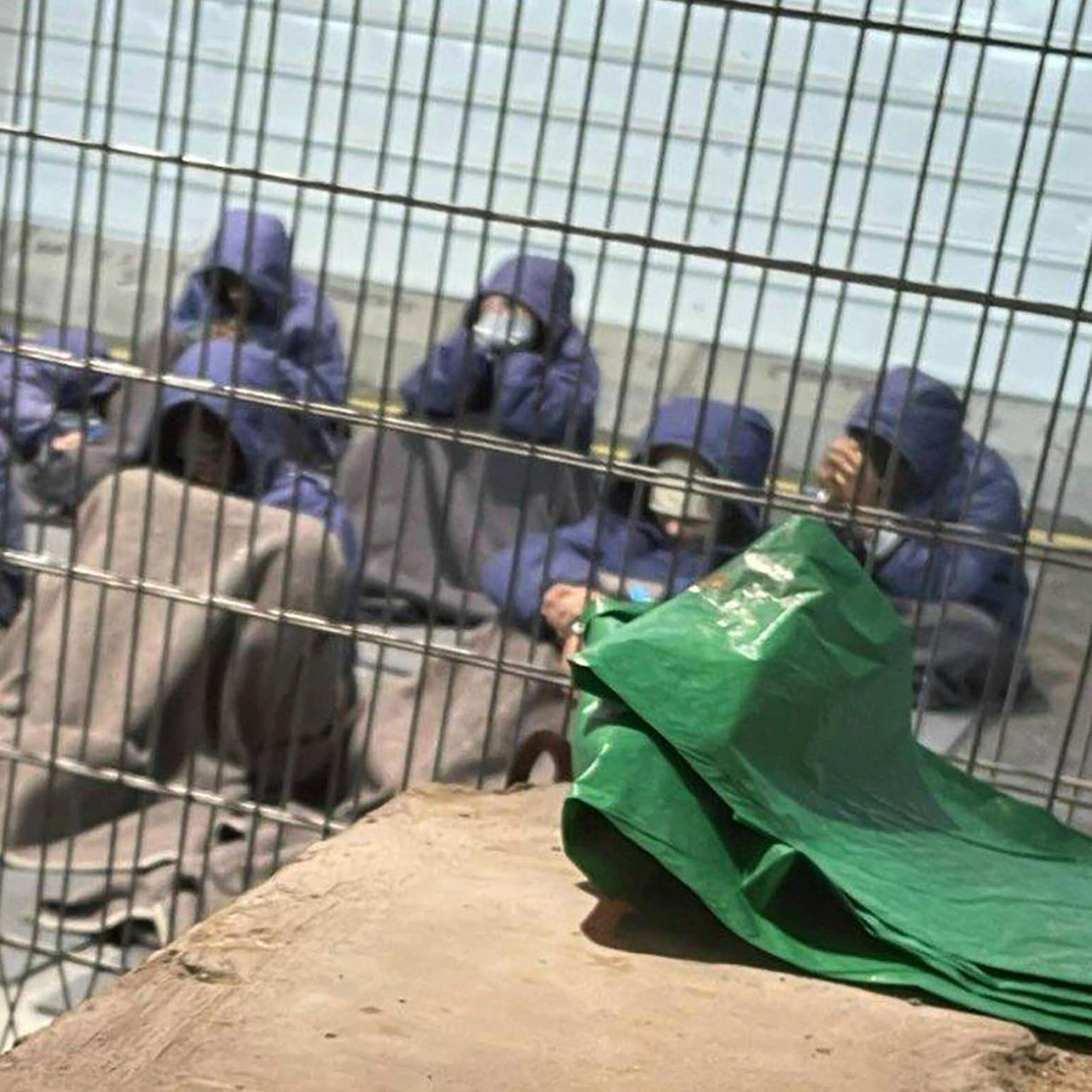 Palestinian men in a prison cell.