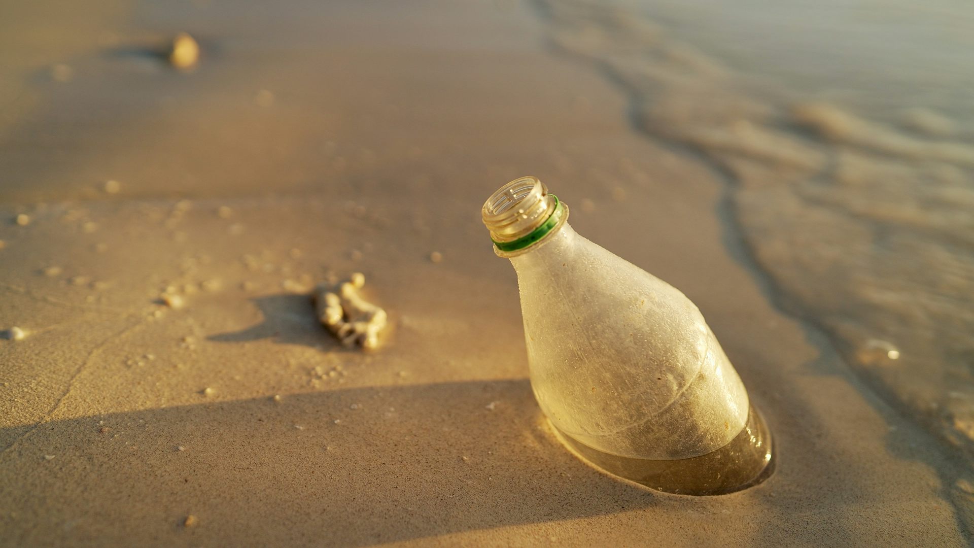 Plastic bottle in beach sand