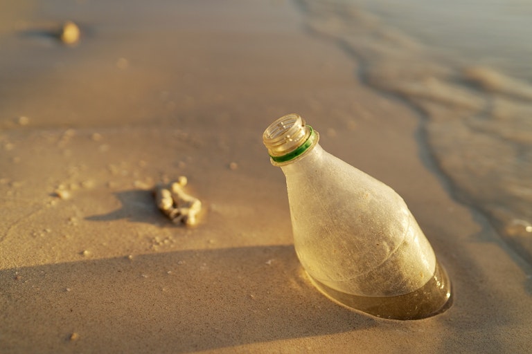 Plastic bottle in beach sand