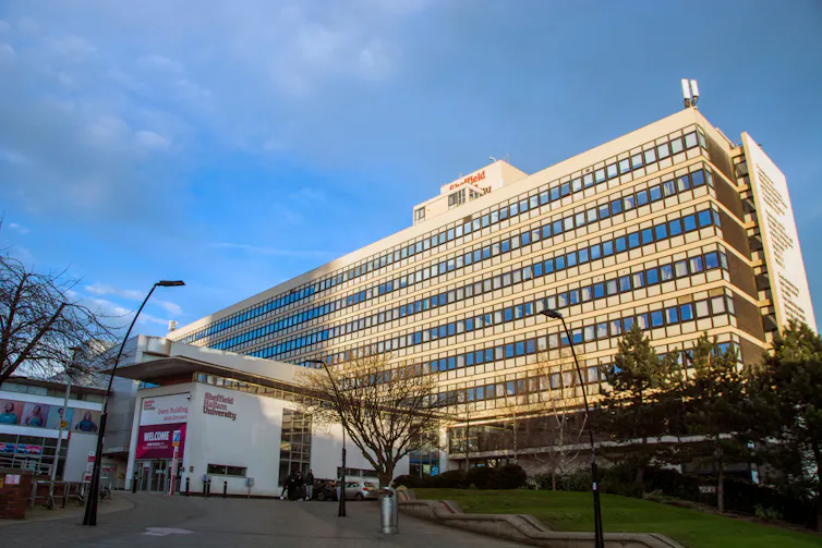 Photo of modern office style building under blue sky