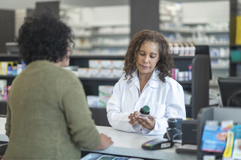 A pharmacist assists a customer