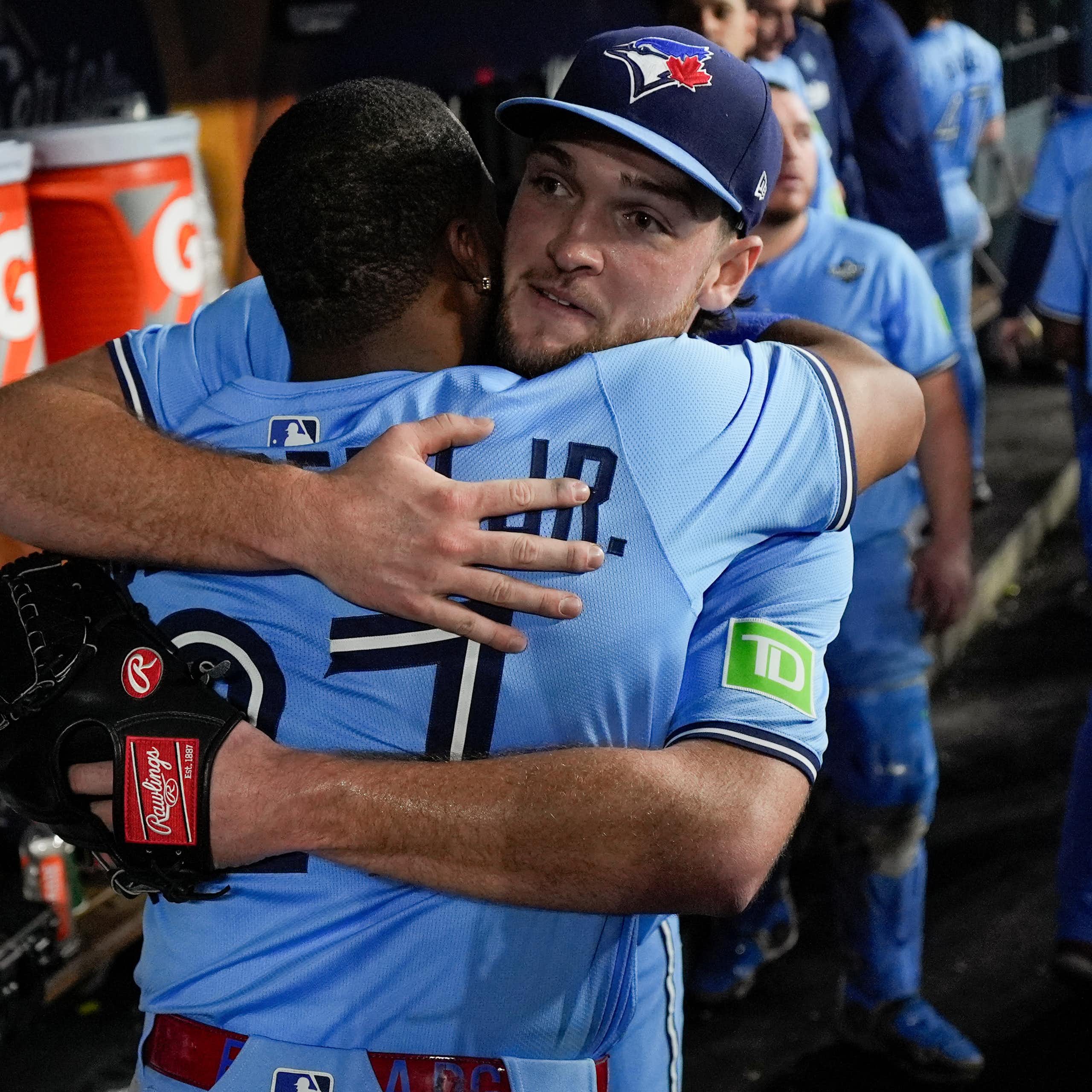 Two baseball players hugging