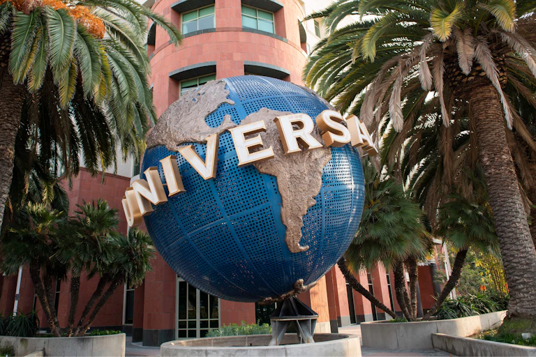 A large globe with the Universal studio in front of a Universal office.