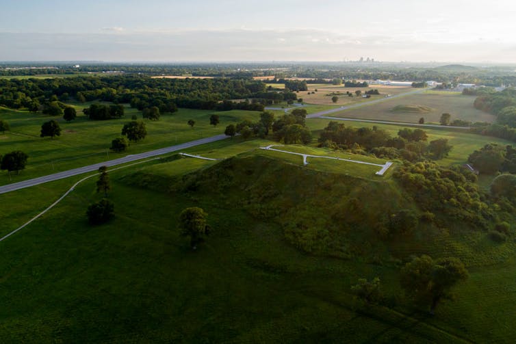 An overhead view of a grassy green area with several raised mounds.