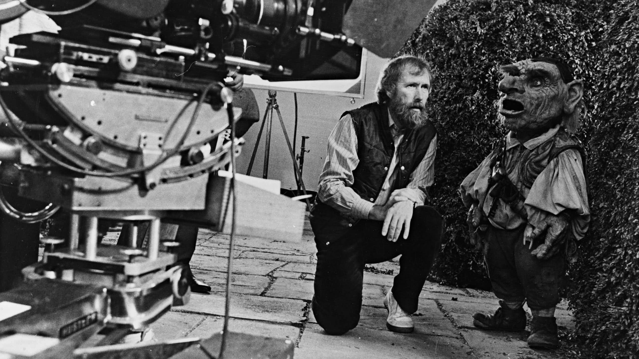 Jim Henson on set with a small puppet