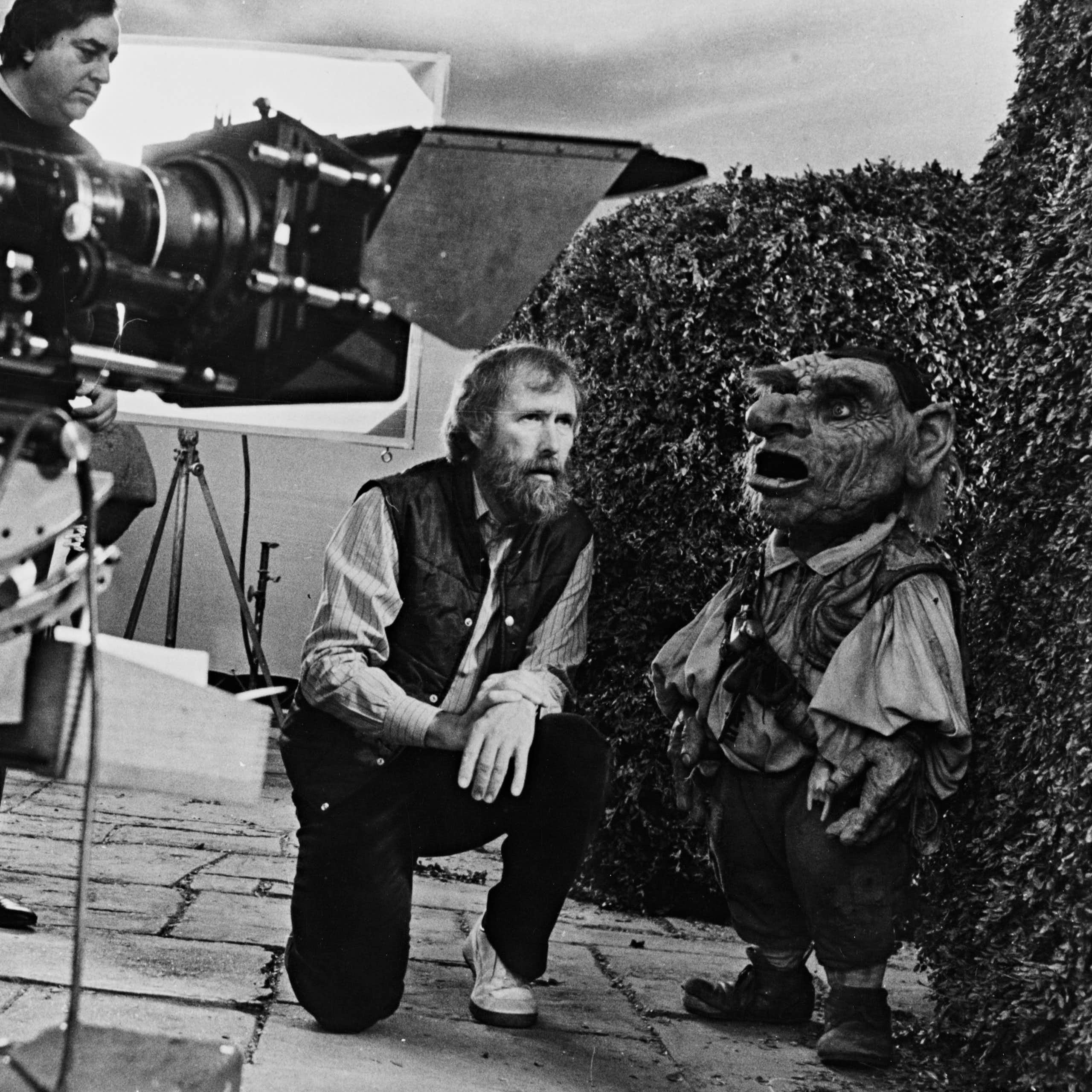 Jim Henson on set with a small puppet